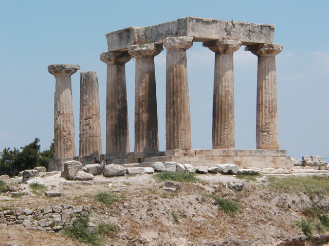 The Temple of Apollo at Corinth. The columns are vertical but appear to lean away from each other.